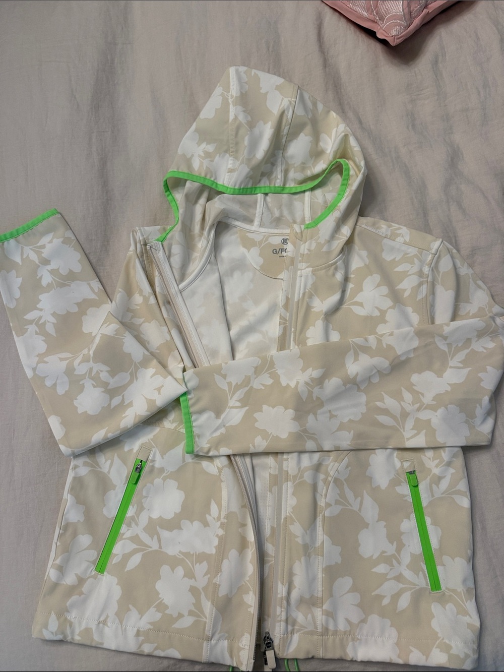 G/FORE Beige Floral Raincoat with Neon Green Trim Accents